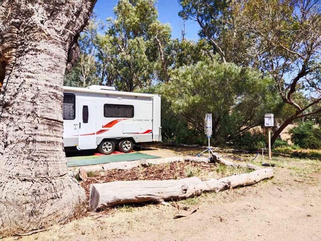 Powered caravan site with a natural bush setting at Quorn Caravan Park, Flinders Ranges, South Australia. 