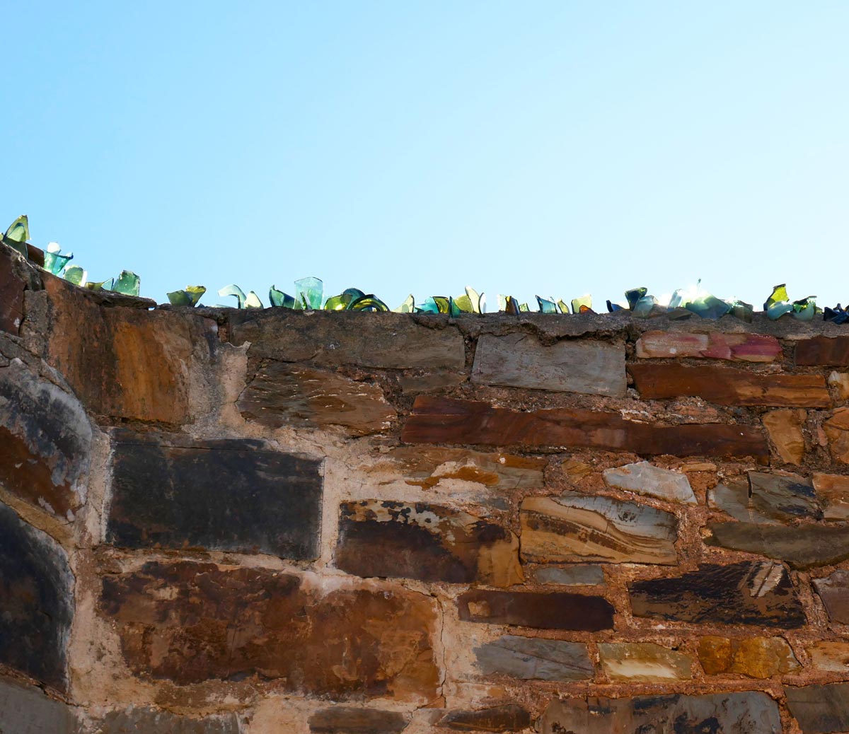 Glass lining the top of the wall at Redruth Gaol. Located in Burra, Clare Valley, South Australia.