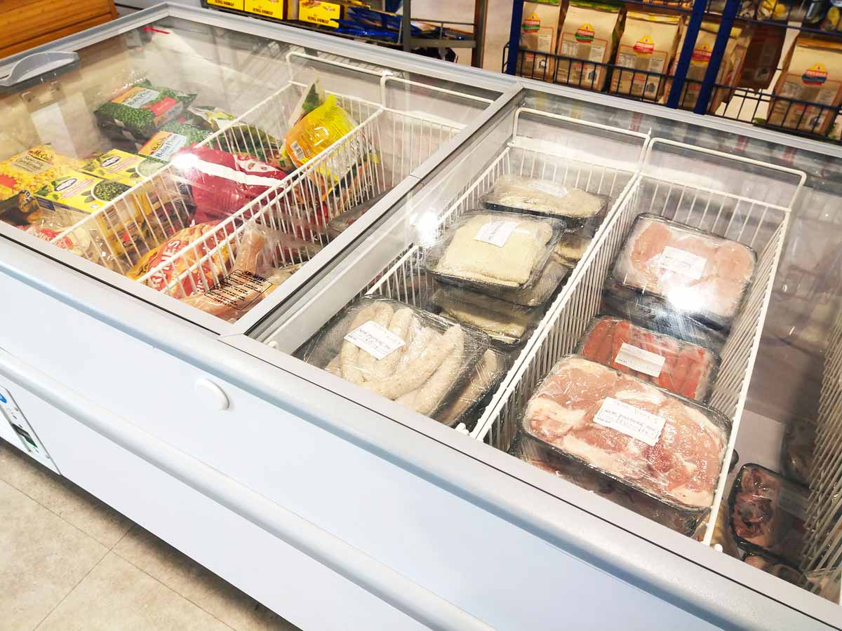 Freezer cabinet with meats and frozen vegetables